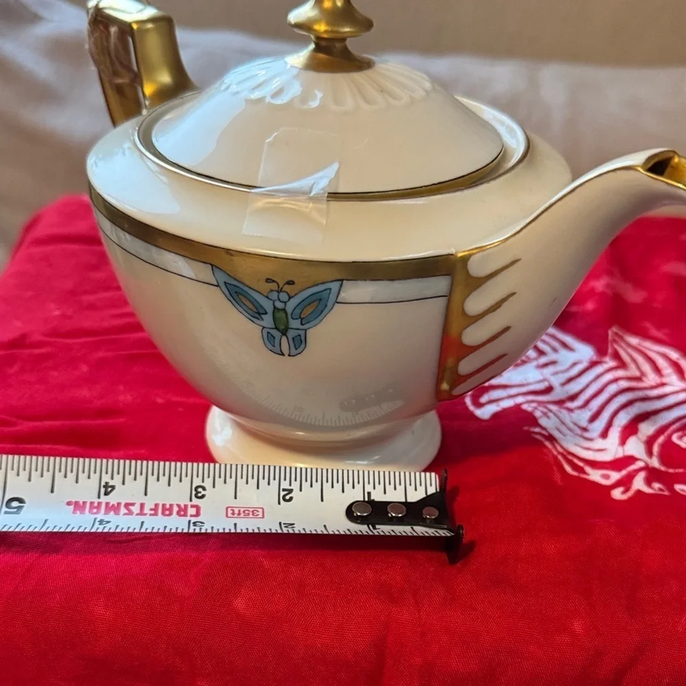 Elegant Gold and Cream Teapot with Blue Accents